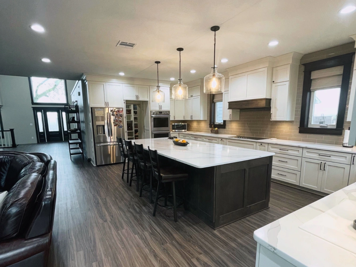 Completed kitchen featuring new lighting, cabinetry, and countertops